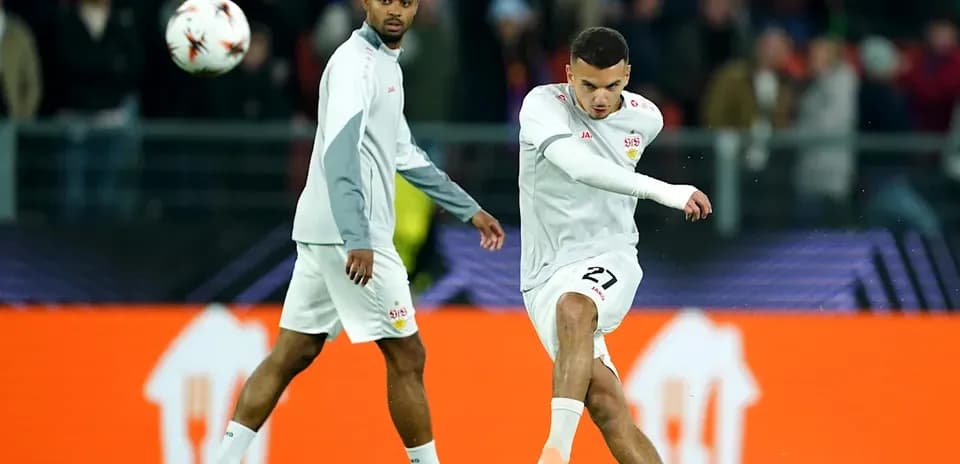 Player kicking ball while teammate looks on
