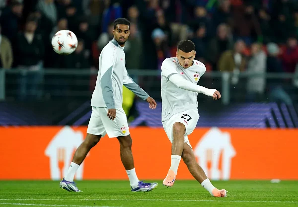 Player kicking ball while teammate looks on