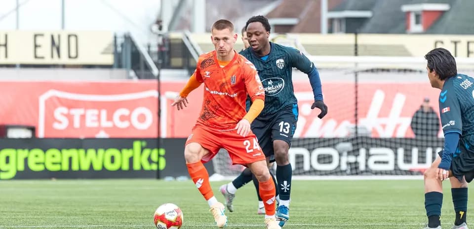 Player in orange jersey dribbling the ball