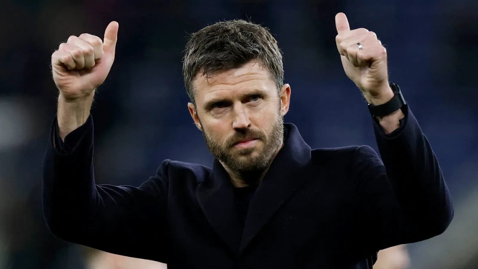 Man giving thumbs up gesture at event