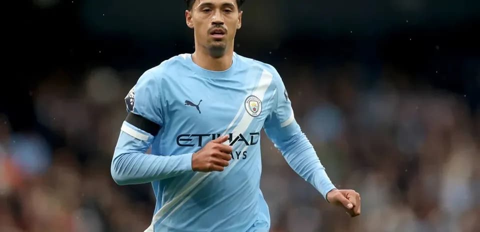 Player running in light blue Manchester City kit