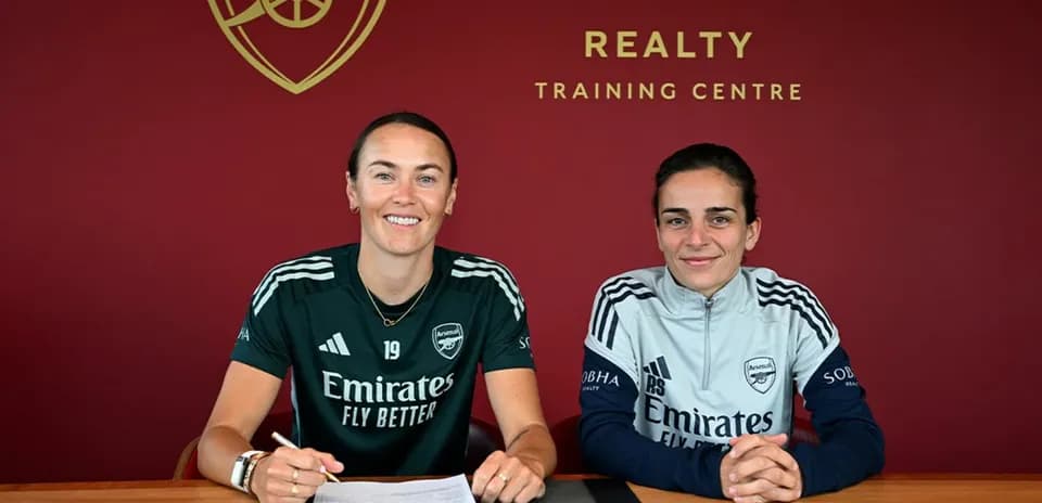 Two players signing contracts at training center