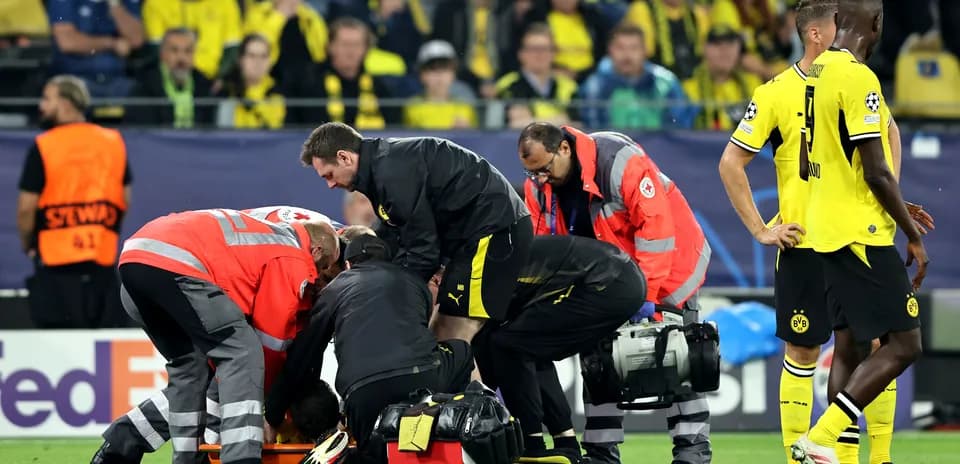 Medical team assisting injured player on field