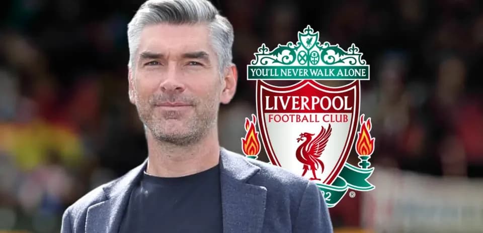 Man in front of Liverpool FC logo and slogan