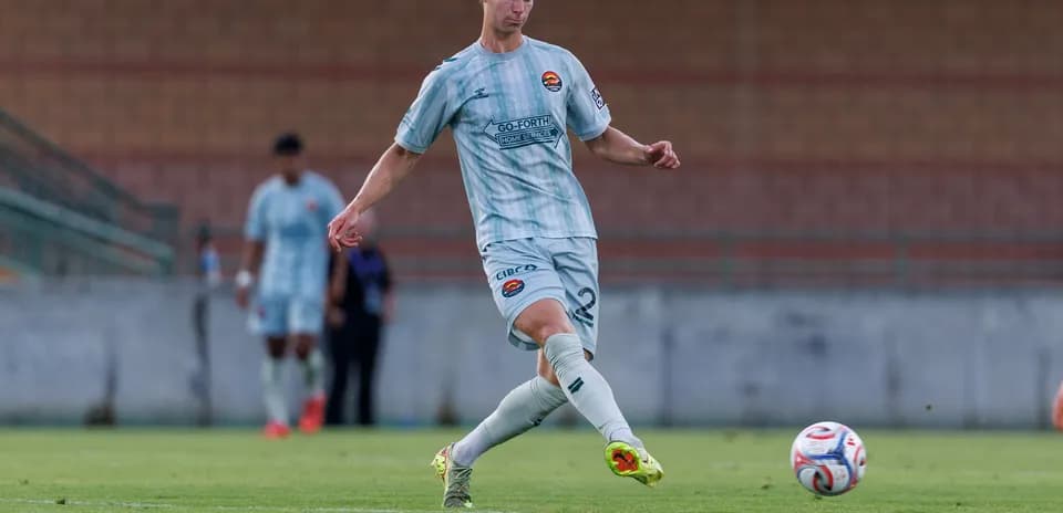 Player kicking ball during MLS Next Pro match