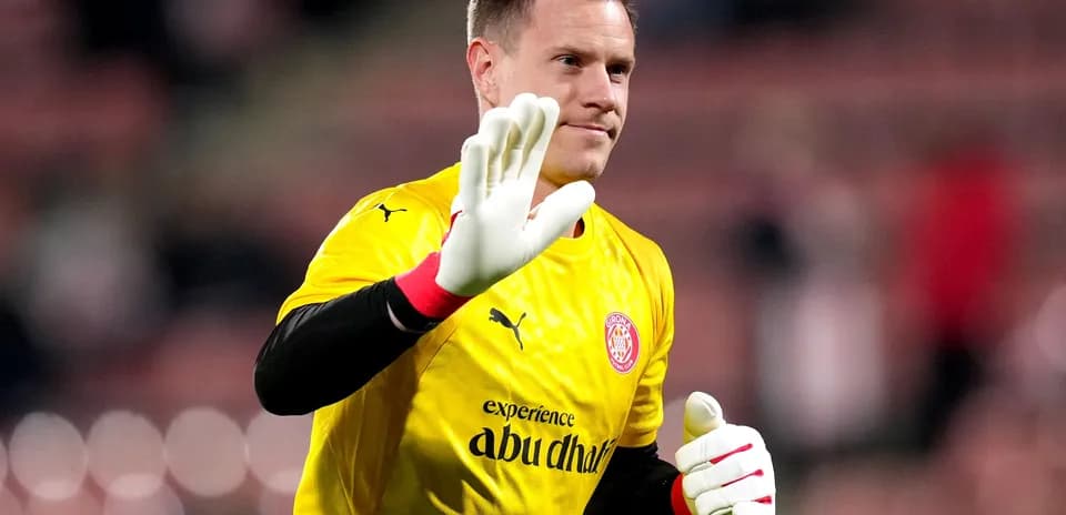 Goalkeeper waving while wearing yellow kit