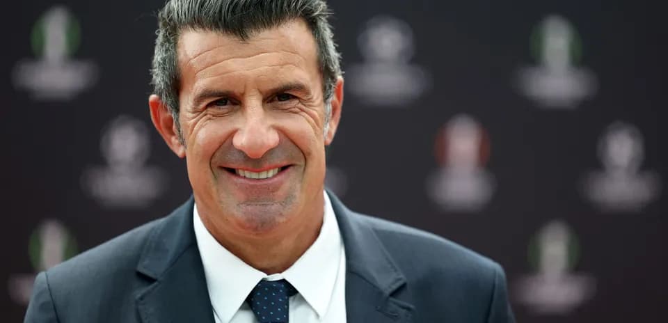 Smiling man in suit at event backdrop