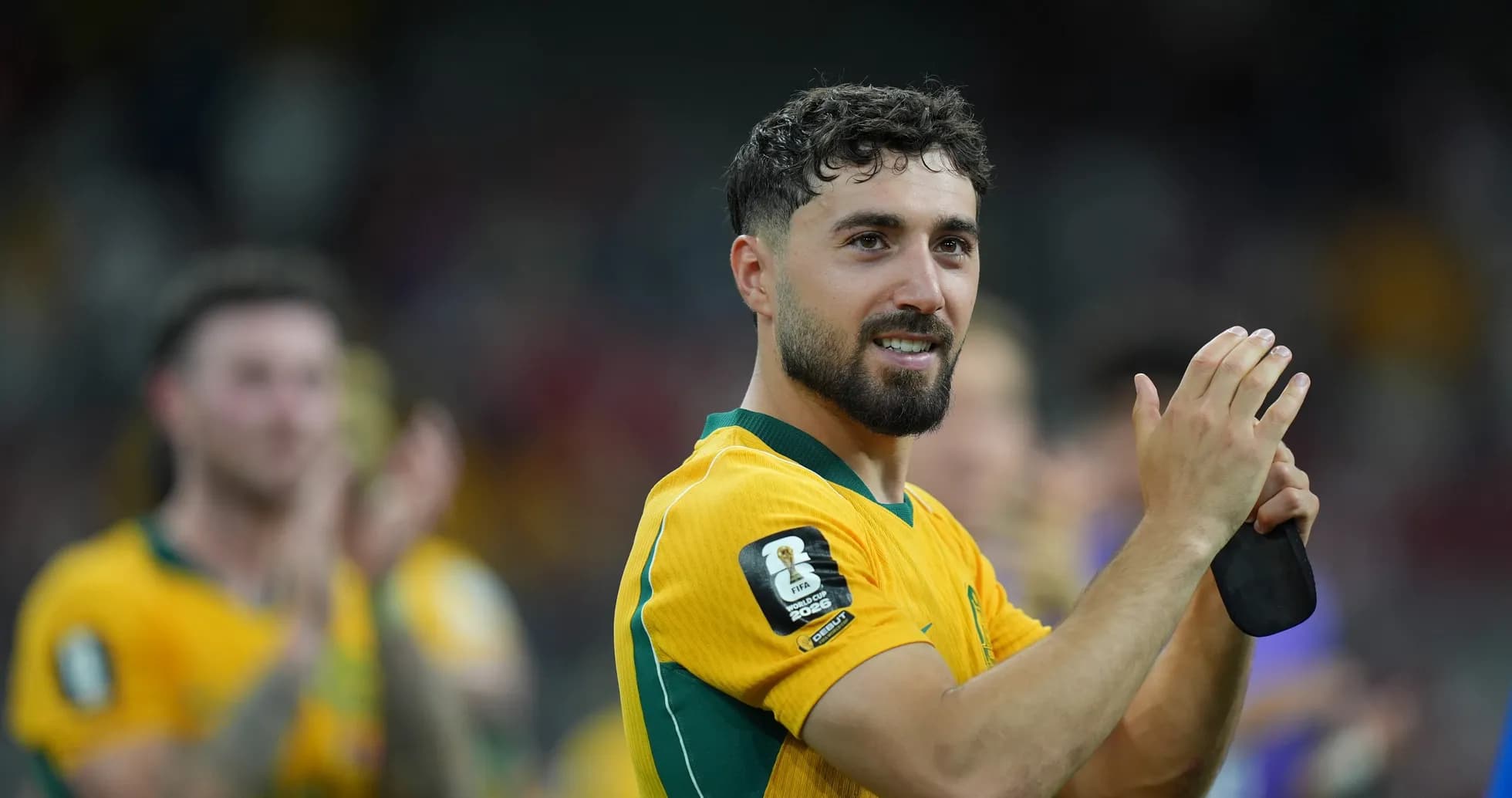 Player celebrating and applauding fans after match