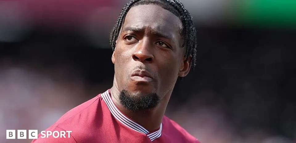 Player in maroon jersey during match warm-up