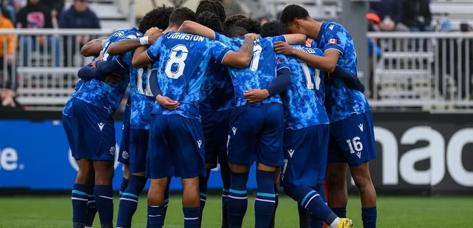 Cavalry FC players huddling before the match