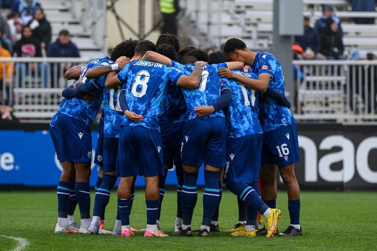 Cavalry FC players huddling before the match