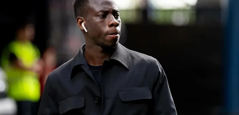 Player walking with AirPods in urban setting