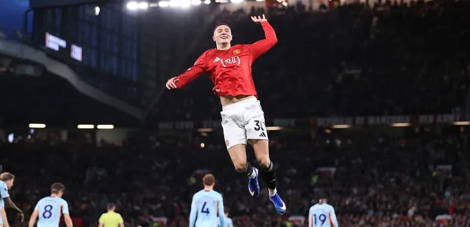 Manchester United player celebrating a goal at Old Trafford