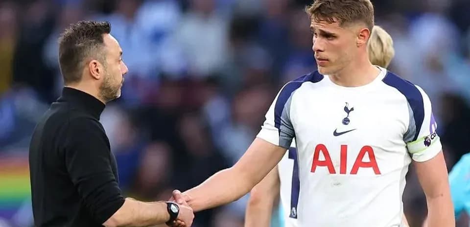 Manager shaking hands with player on pitch