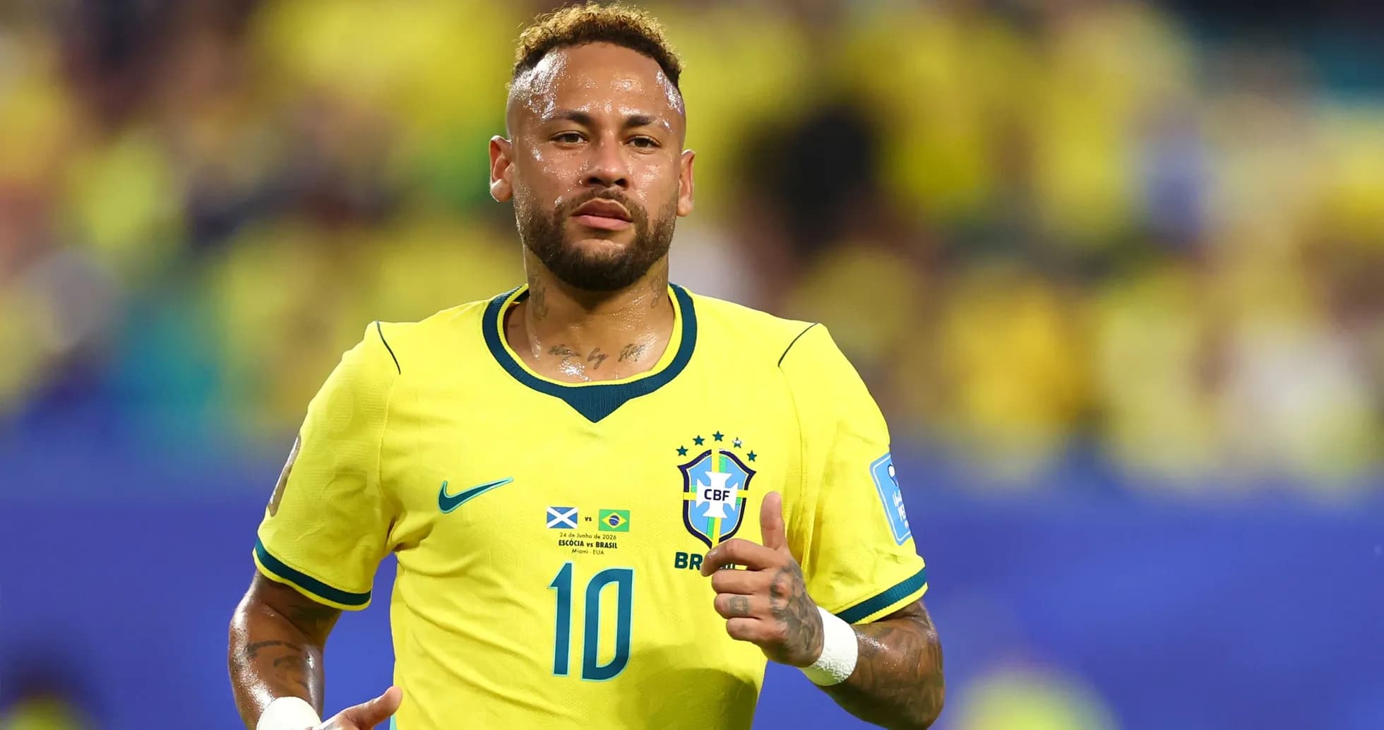 Neymar running in Brazil's yellow football kit