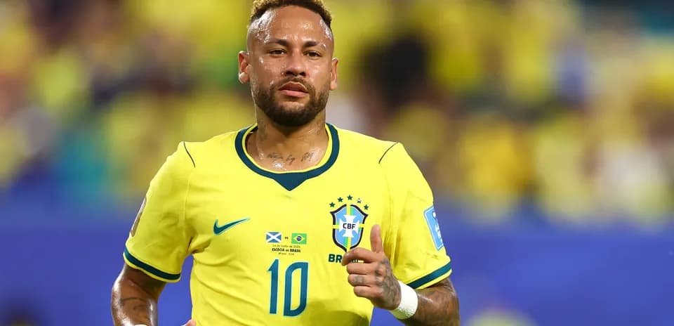 Neymar running in Brazil's yellow football kit