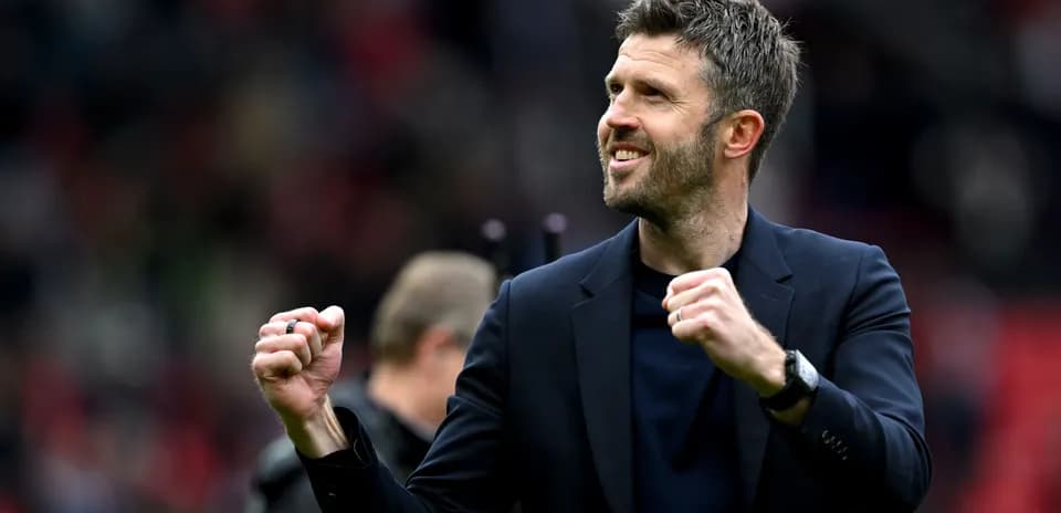 Manager celebrating with clenched fists on pitch
