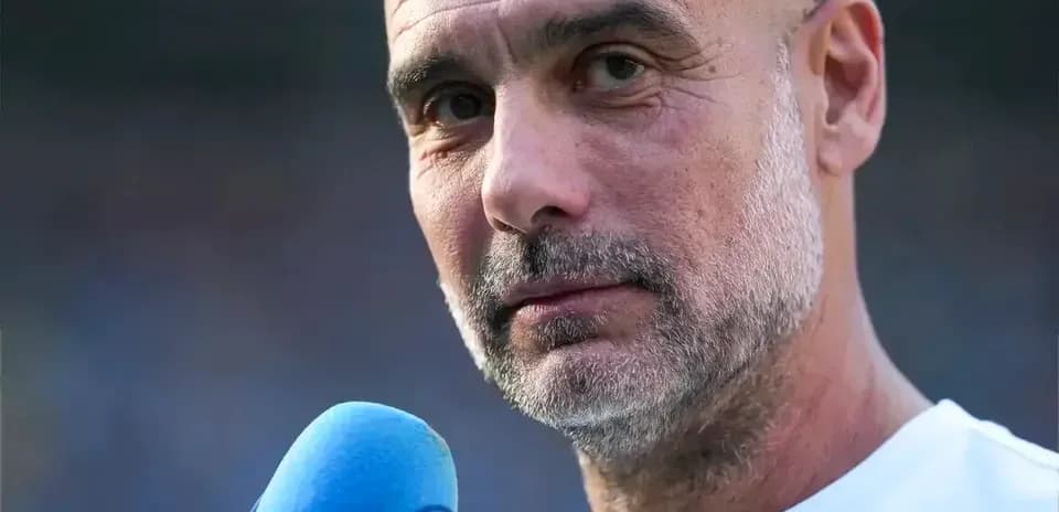 Coach speaking into microphone during press event