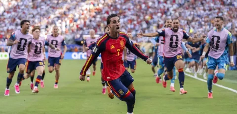 Spain player celebrating with teammates after scoring