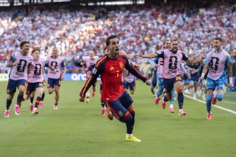 Spain player celebrating with teammates after scoring