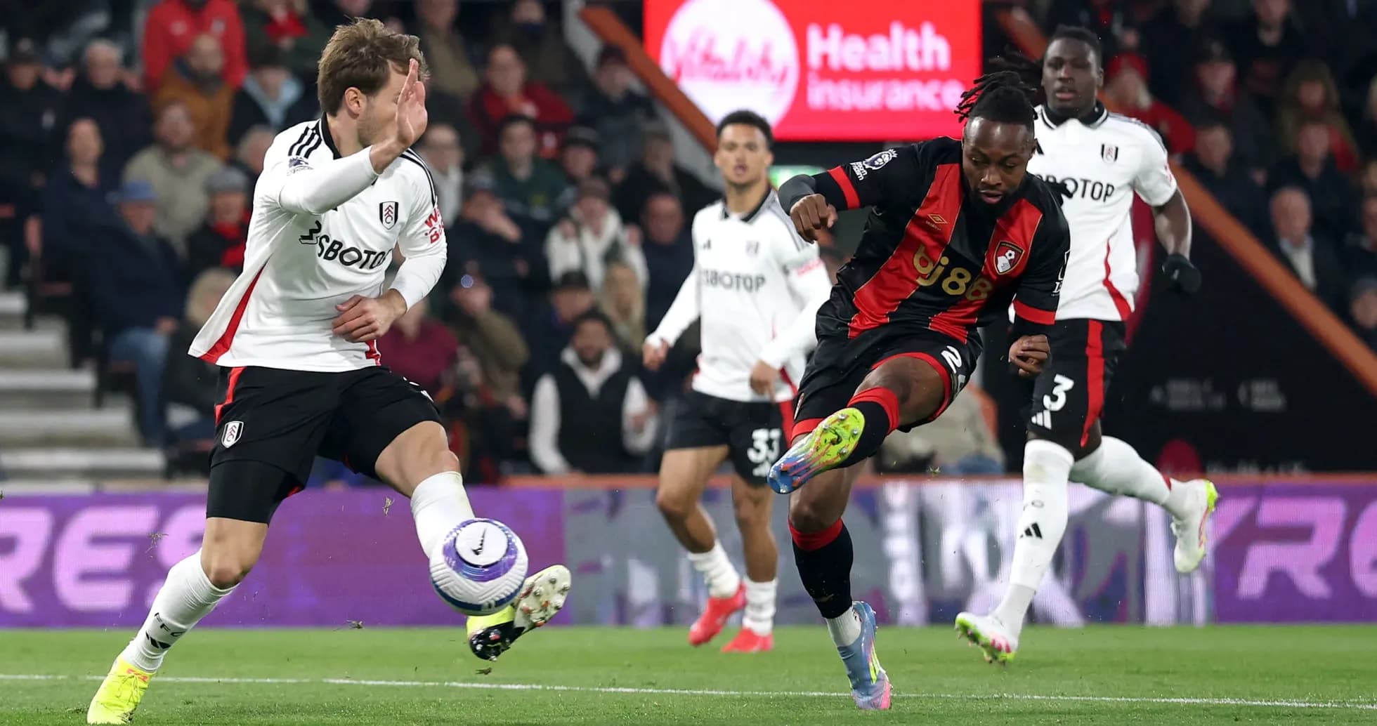 Fulham and Bournemouth players contesting for the ball
