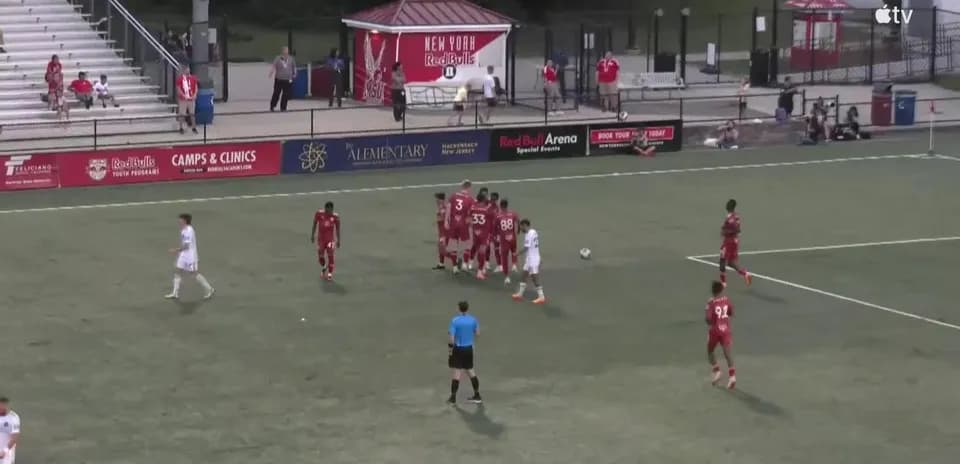Players preparing for a free kick in match