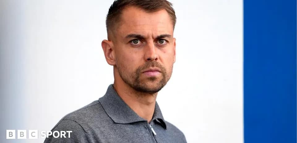 Man in gray polo shirt looking at camera
