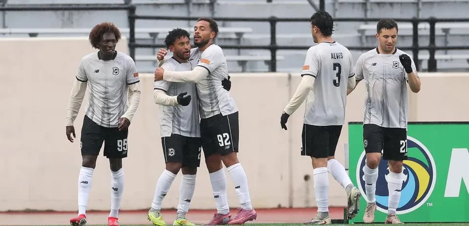 Players celebrating a goal during USL match
