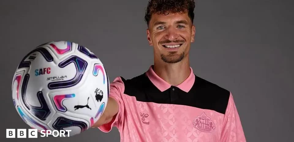 Player posing with a soccer ball in studio