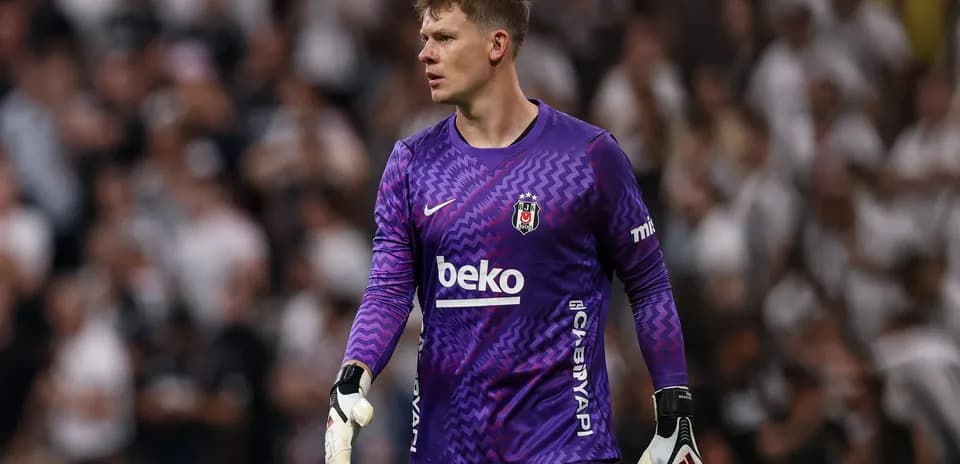 Goalkeeper in purple kit during match action