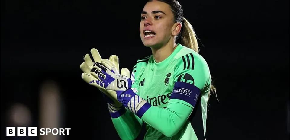 Goalkeeper in green jersey directing teammates during match