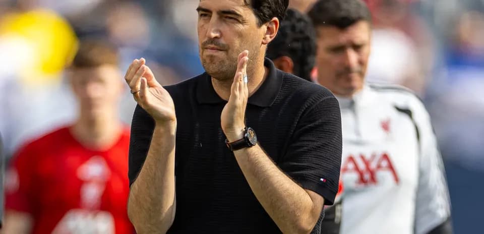 Coach applauding players during match warm-up