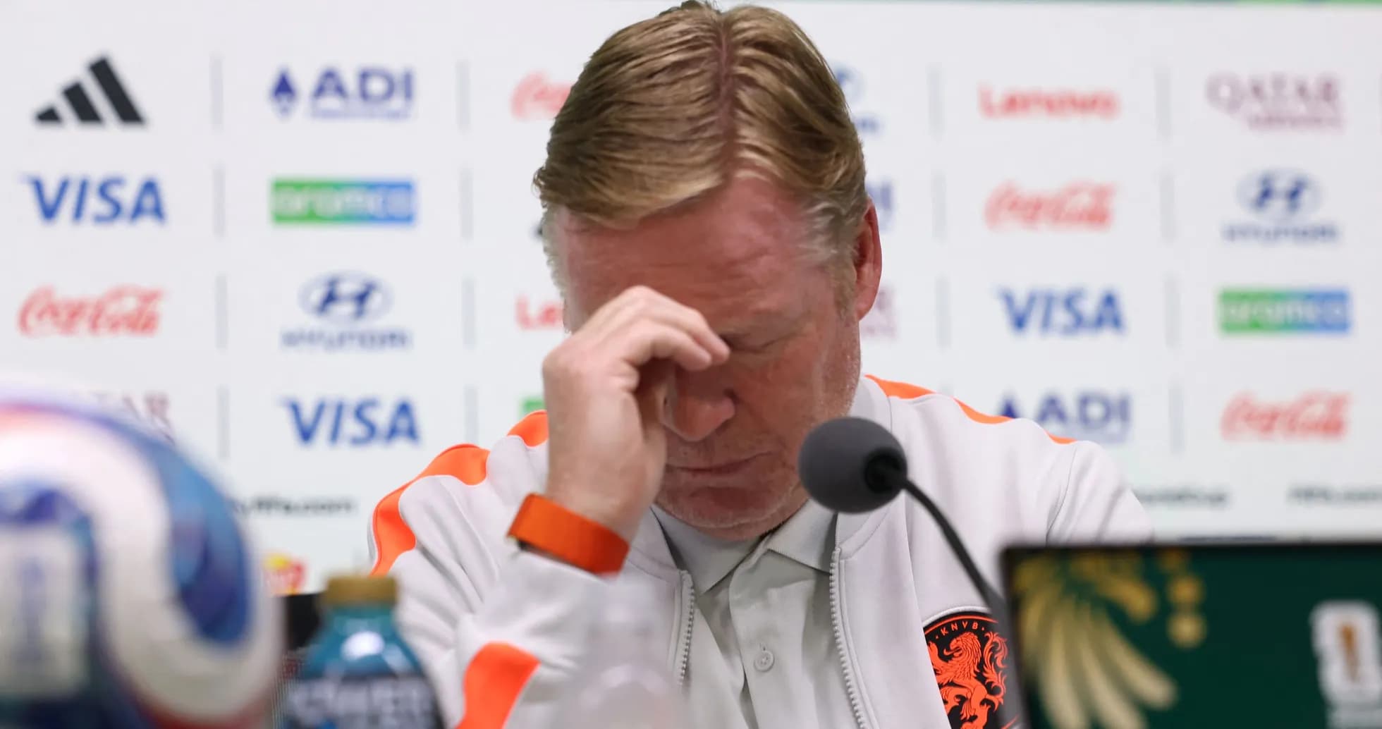 Manager at press conference with head down