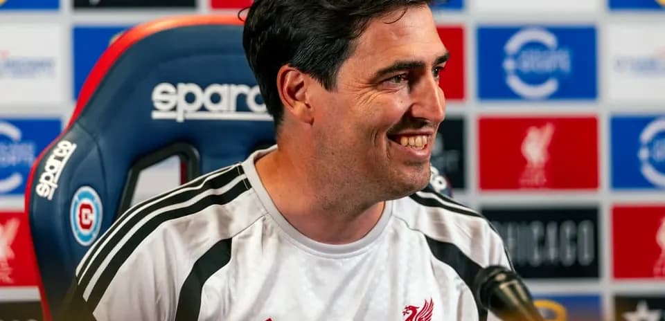 Manager at press conference with team logo backdrop