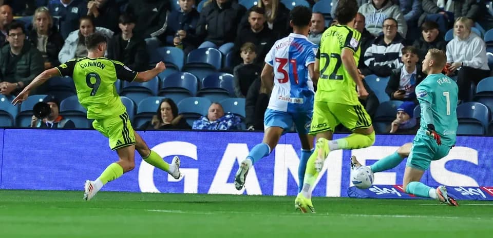 Player shooting at goal during football match