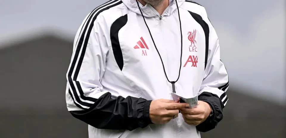 Coach smiling during Liverpool training session