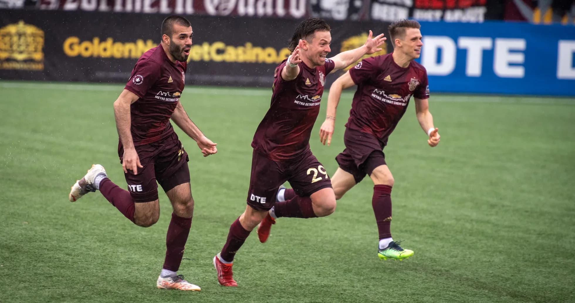 Detroit City players celebrating a goal