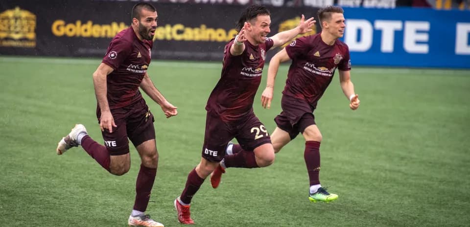 Detroit City players celebrating a goal
