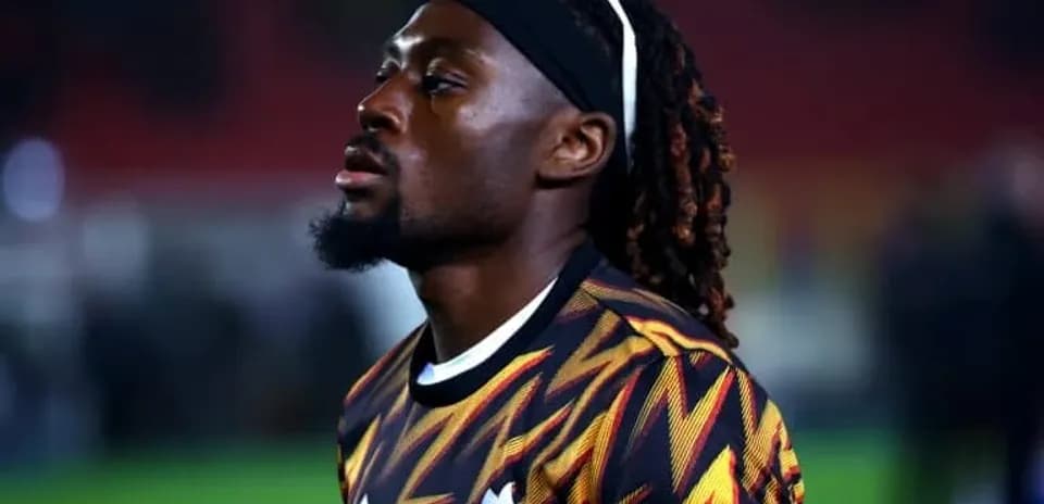 Player in colorful jersey during pre-match warm-up