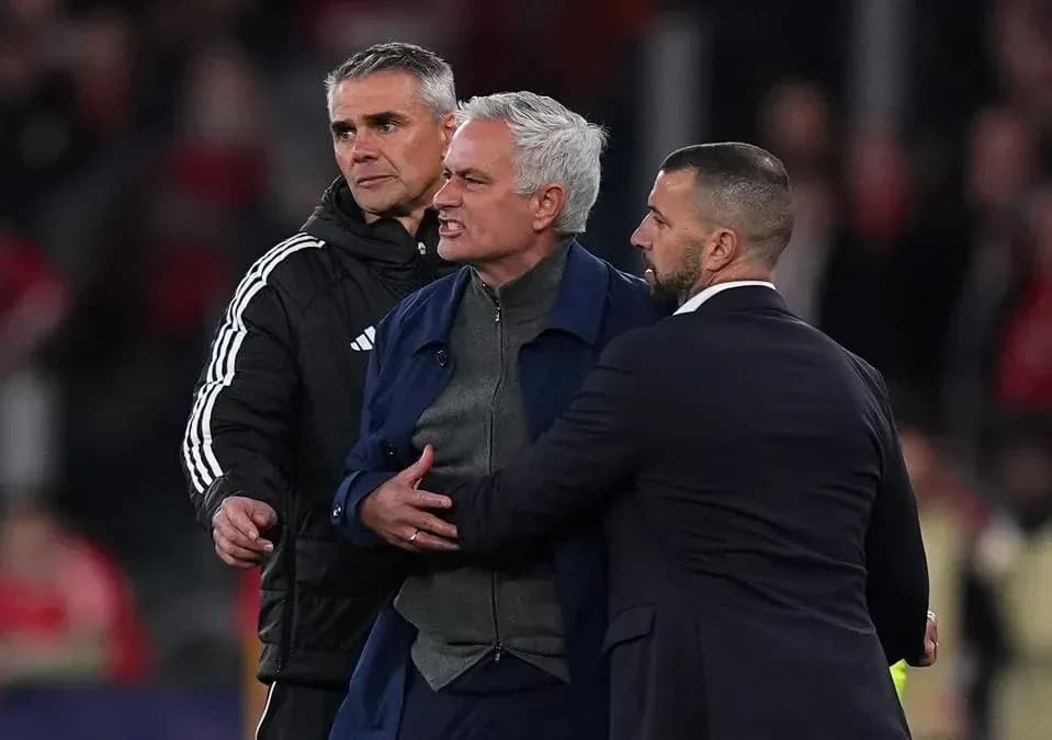 Manager being restrained by staff during match