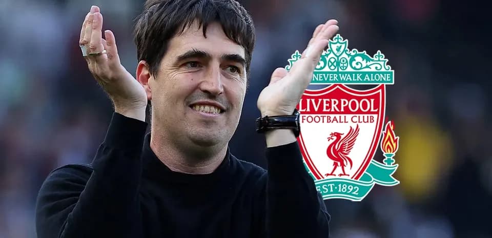 Coach applauding with Liverpool logo in background