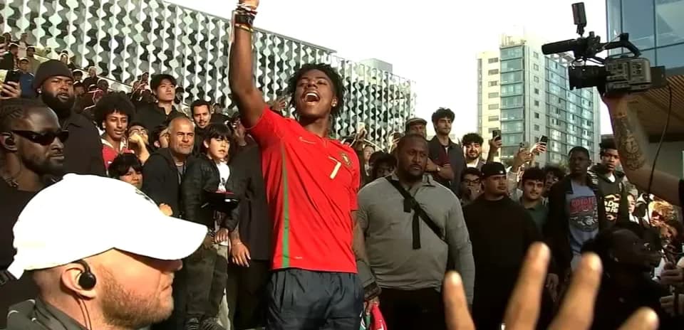 Fan in Portugal jersey leading crowd during event