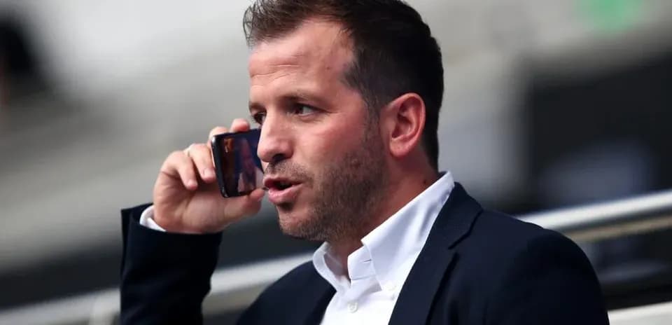 Man speaking on the phone in a stadium
