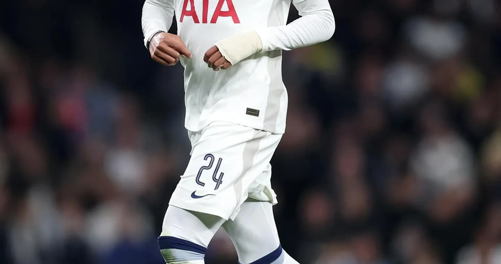 Player in Tottenham kit running with a soccer ball
