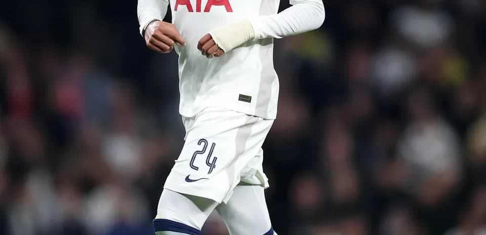 Player in Tottenham kit running with a soccer ball