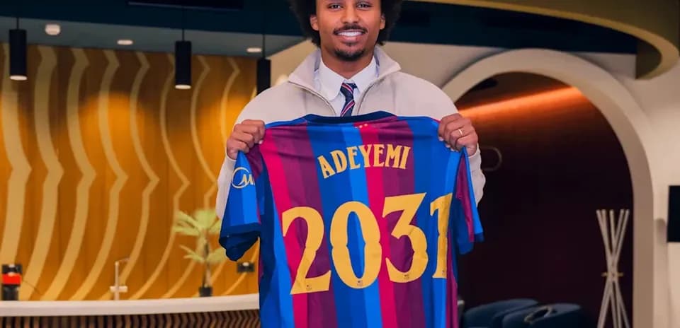 Player holding FC Barcelona jersey with name Adeyemi
