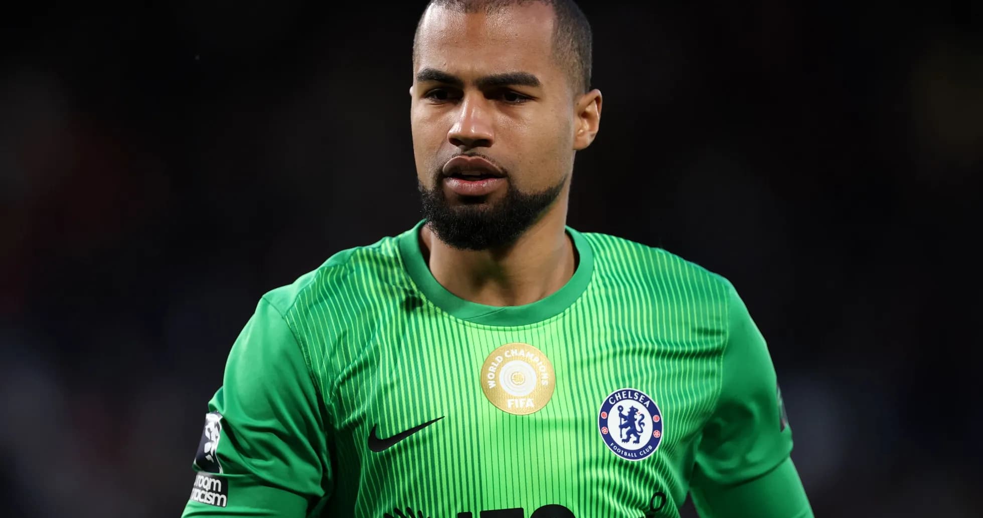 Goalkeeper in green kit during match preparation