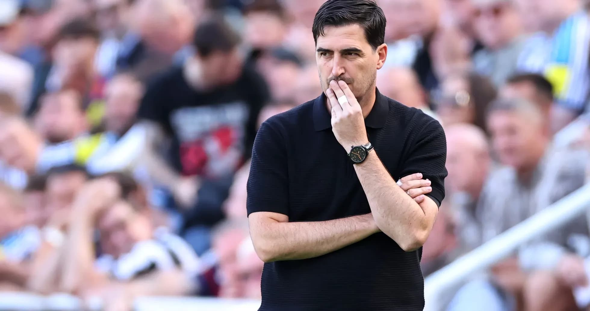 Coach observing the match with crossed arms