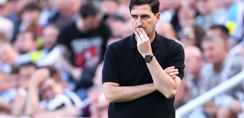 Coach observing the match with crossed arms