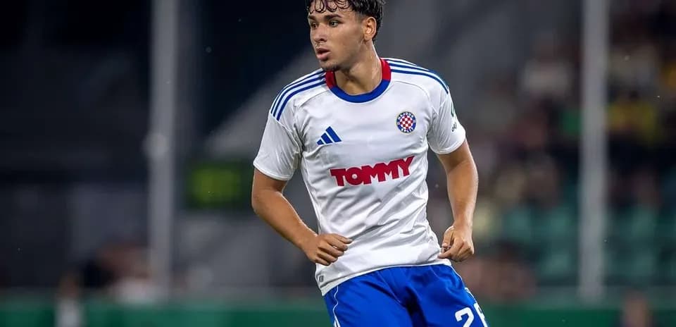 Player wearing white and blue kit during match